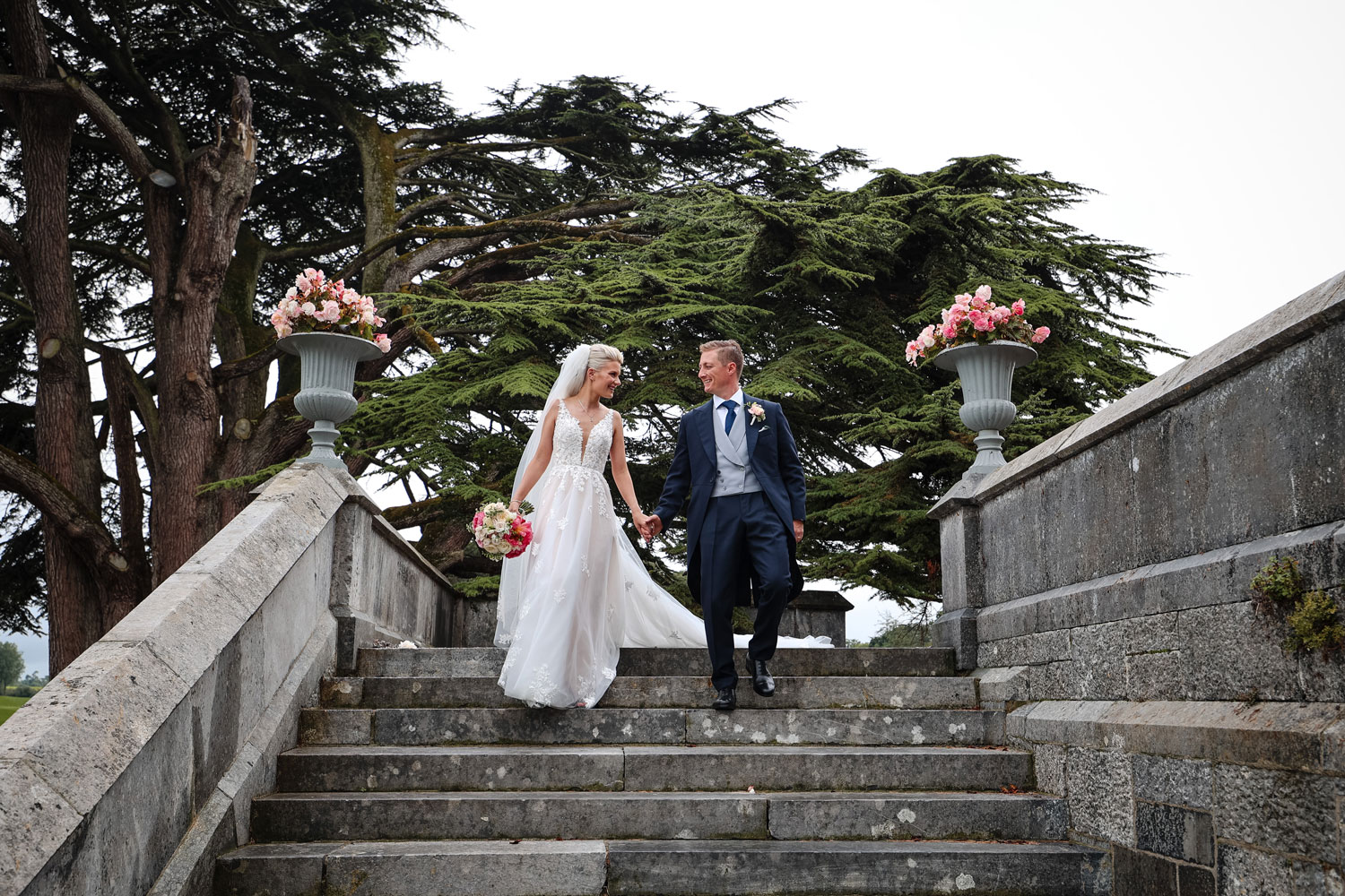 Married couple walking in the grounds of Adare Manor on their wedding day