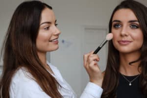 Makeup Artist applying makeup to a Bride