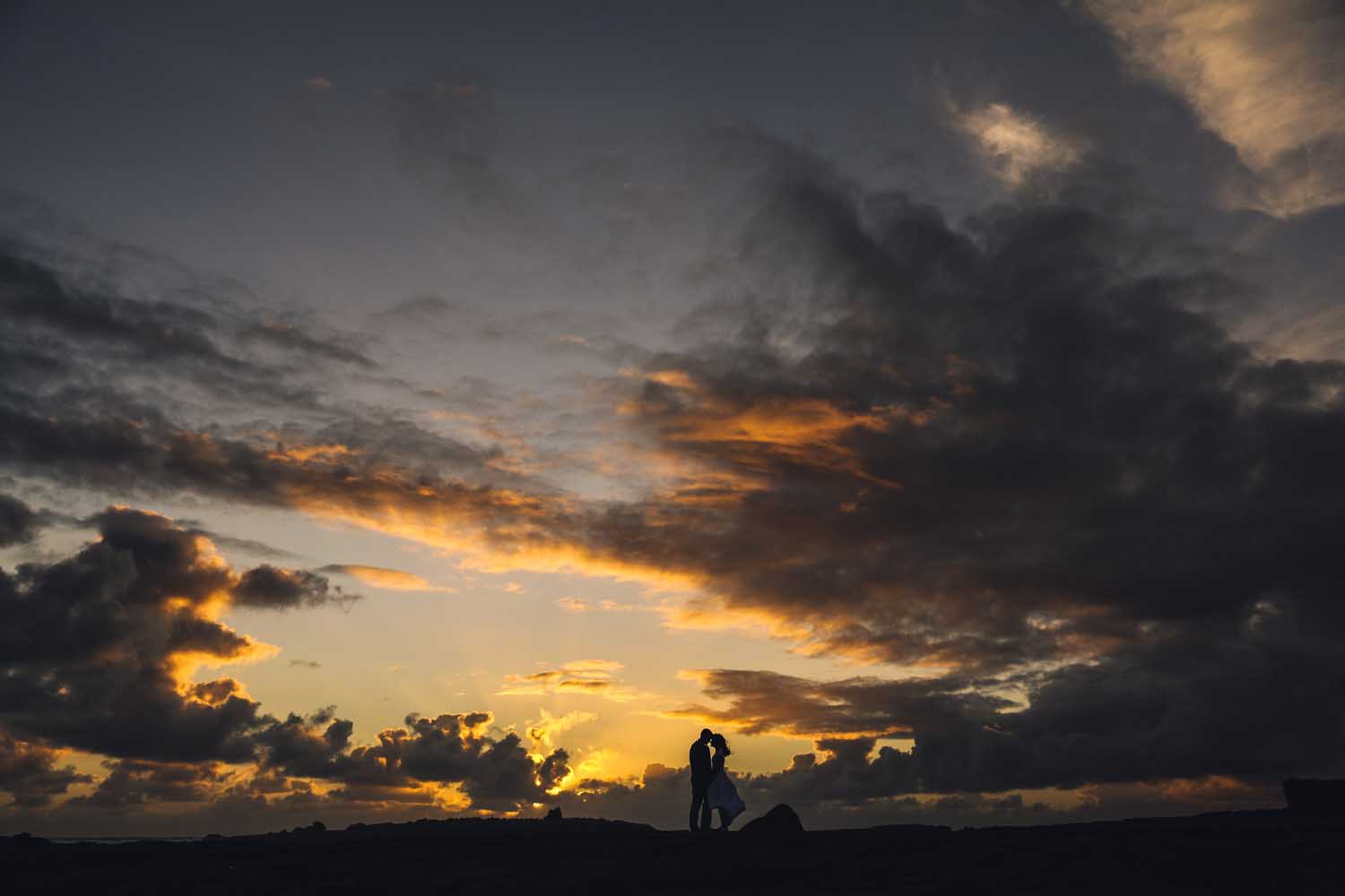 Married couple embrace at sunset on the Wild Atlantic Way