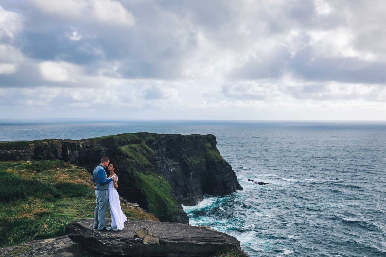 Married couple embrace at the Cliffs of Moher