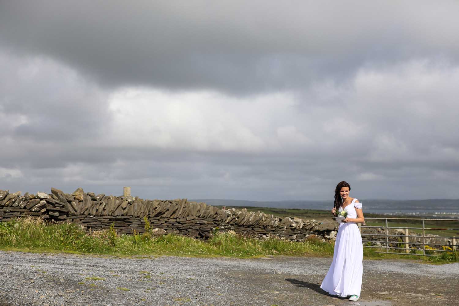 Bride standing against the irish countryside