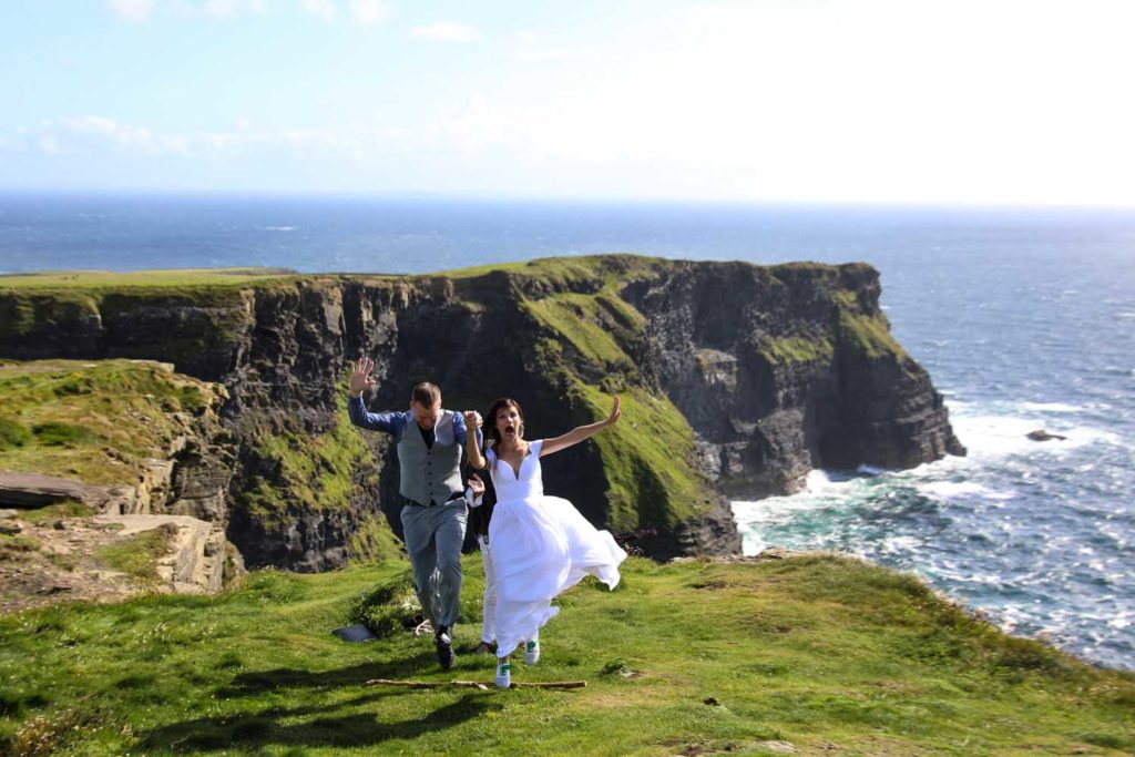 Couple jumping for joy on their elopement