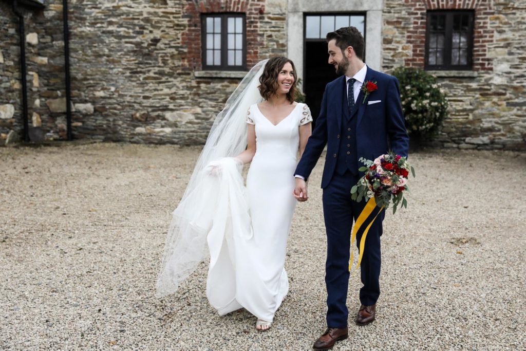 Newly married couple walking together outside Ballybeg House, Co. Wicklow