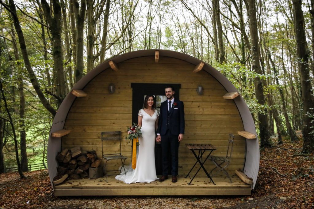 Married couple on their wedding day outside one of the guest accommodation pods at Ballybeg House, Co. Wicklow