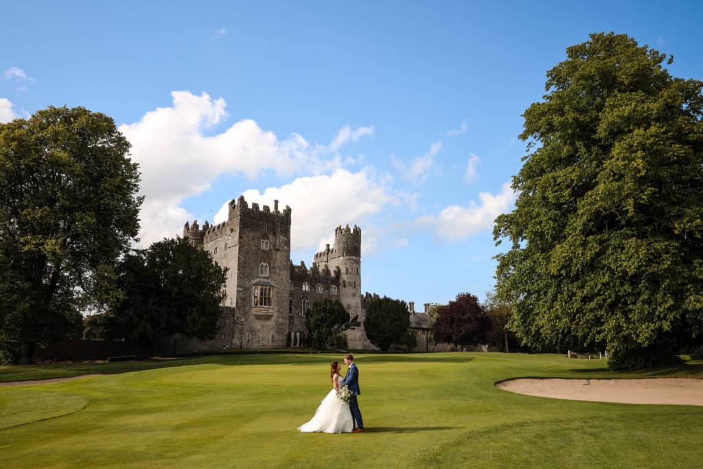 Married couple posing at Kilkea Castle on their wedding day
