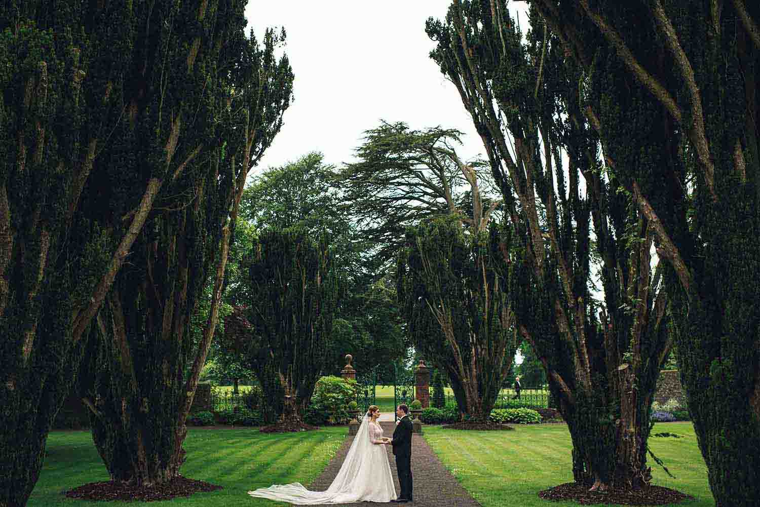 Bride and groom together in the gardens on their wedding day