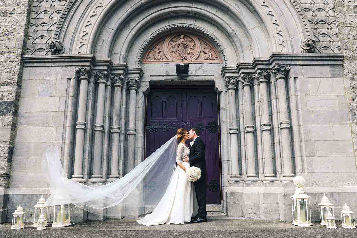 Bride and Groom kiss outside St Mary’s Church