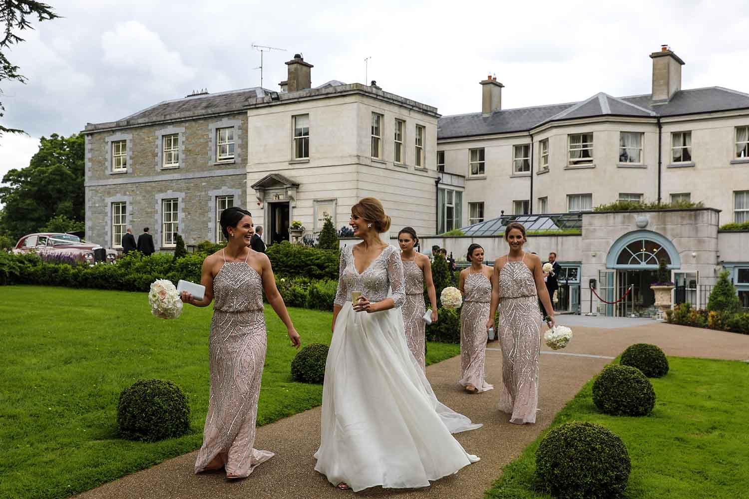 Bridal party strolling through the grounds of Tankardstown House