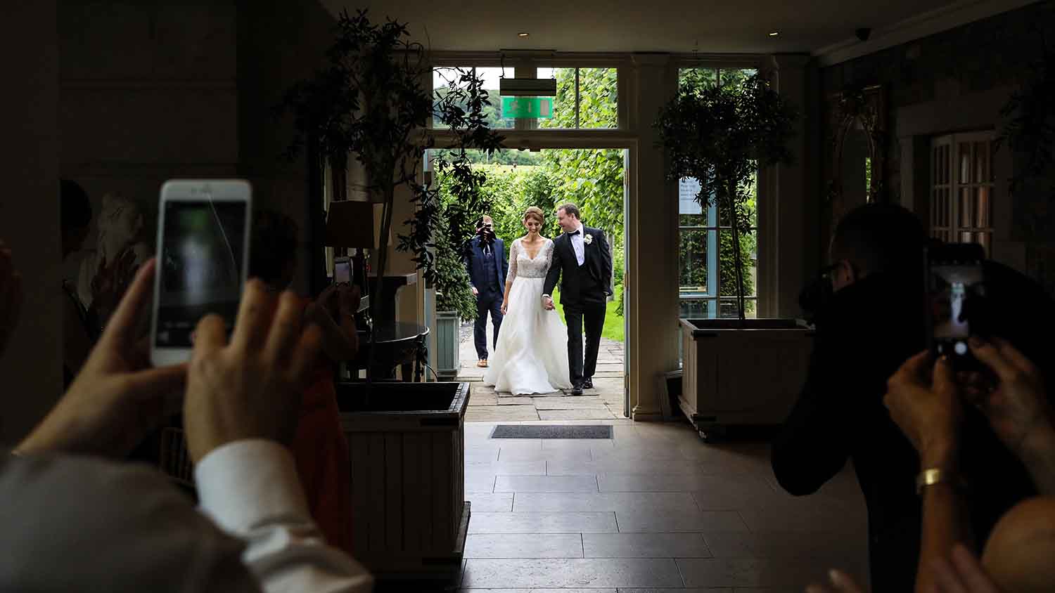 Couple entering the reception room on their wedding day
