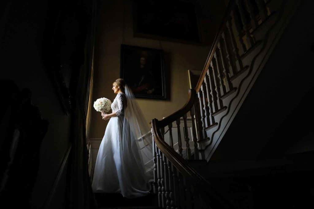 Bride standing on the staircase at Tankardstown House