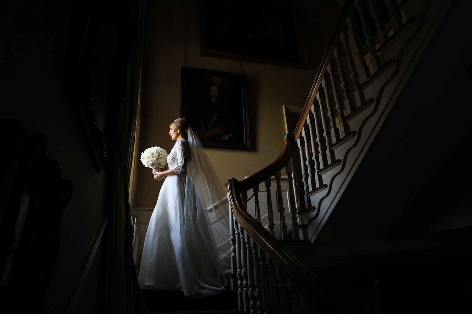 Bride at the top of the staircase at Tankardstown House
