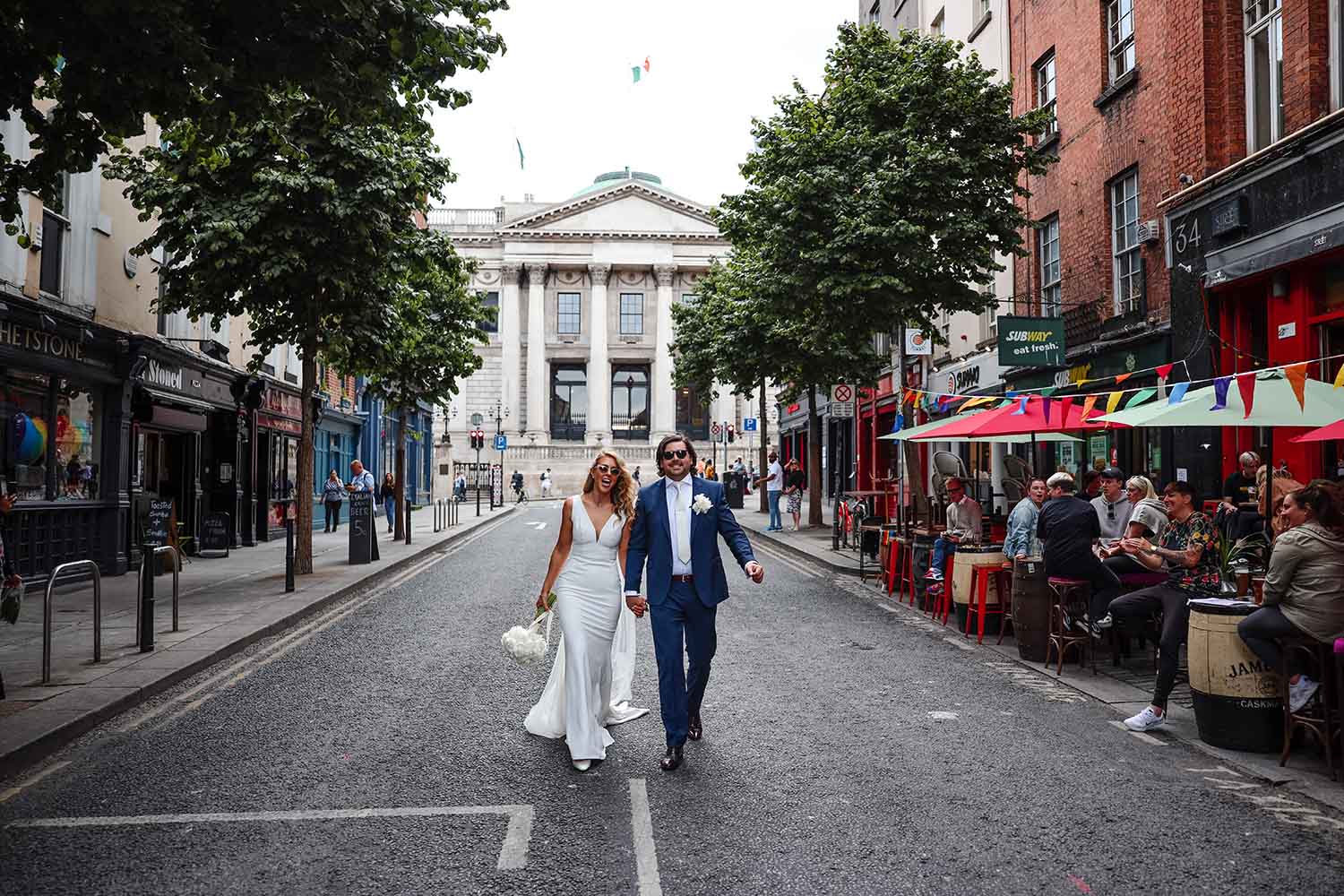 Newly Married couple walking on Parliament Street with Dublin City Hall in the background