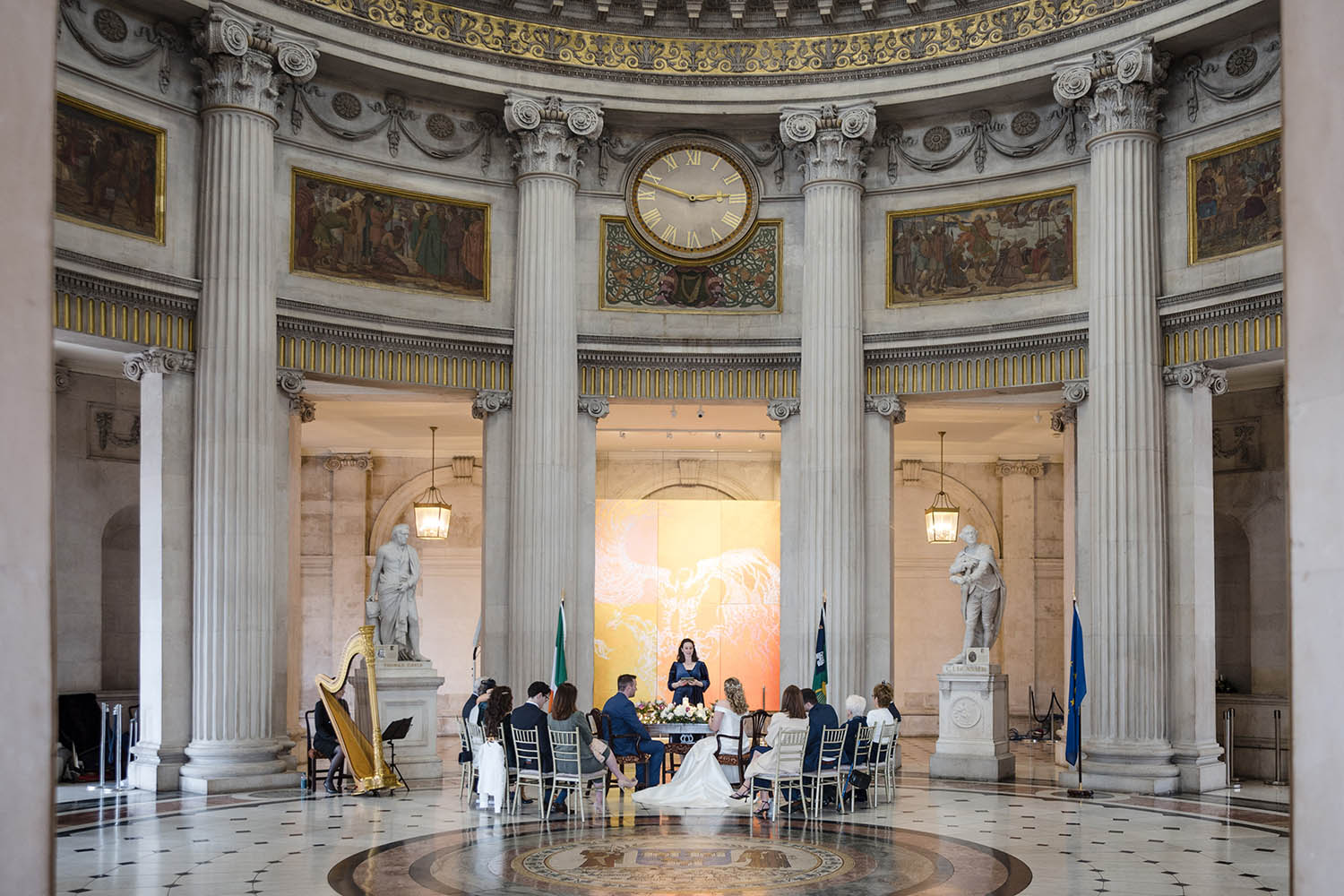 Small wedding party and harpist during a marriage ceremony at Dublin City Hall